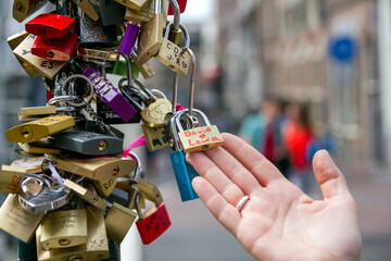 Love safety locks over a Amsterdam canal bridge. Love and travel concept.