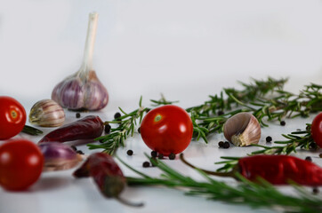 Food and drink healthy lifestyle concept: Italian herbs and spices. Rosemary, tomatoes, garlic and peppers. Top view. Isolated on white. Tomatoes and various herbs spices isolated on white background