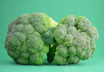 Broccoli on a green background, a complete vegetable full of properties. Copy space.