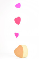 Happy Valentine's Day, hearts in the air and a big one of kraft paper on the white base. Copy space.