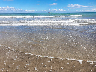 waves on the beach. Tropical beach with yellow sand and blue water. A summer vacation, holiday background of a beach 
