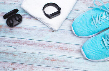 sports shoes, headphones, fitness bracelet on a white background. top view.