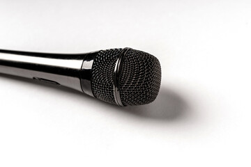Black microphone on isolated white background, space for text