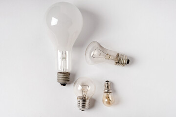 Incandescent lamps of different patterns and sizes on a white background