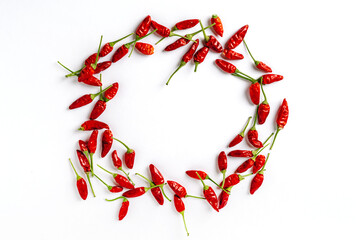 Red chili peppers are laid out on a white background in the form of a frame, a place for text