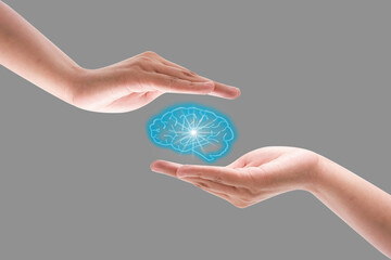 Drawn brain idea hovered over the human hand on the gray wall background