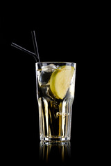 Transparent yellow cocktail isolated on black
