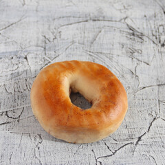 Fresh bagels on a grunge background. Two halves of the bagel. Food and breakfast concept.