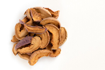 Slices of sun dried fruits dehydrated apples on white background.