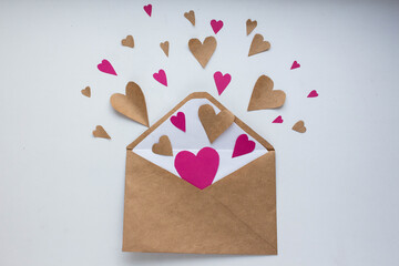 Letter with hearts
Valentine day love letter. Envelope from craft paper with red hearts heap spread...