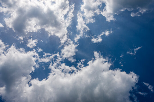 Beautiful blue sky with white cumulus clouds (cumulonimbus), bottom view, full frame, photography.