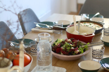 Bowl with lettuce and cabbage salad, served on the table. Selective focus.