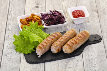 Grilled sausages served mushrooms and cabbage