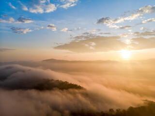 Naklejka na ściany i meble Aerial view forest in morning fog mist, breathing mountains, Sunshine on The Morning Mist