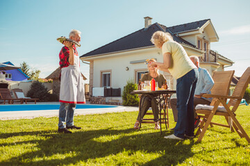 Elderly people having friends over for an outdoor lunch