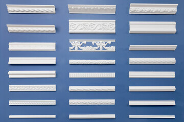 Set wood molding ceiling and floor skirting board on isolated blue background - obrazy, fototapety, plakaty