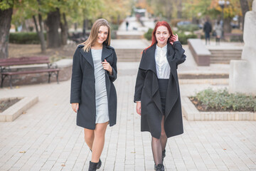 Two cute young girls are walking and talking about important topics