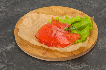 Sliced salmon fillet served rosemary