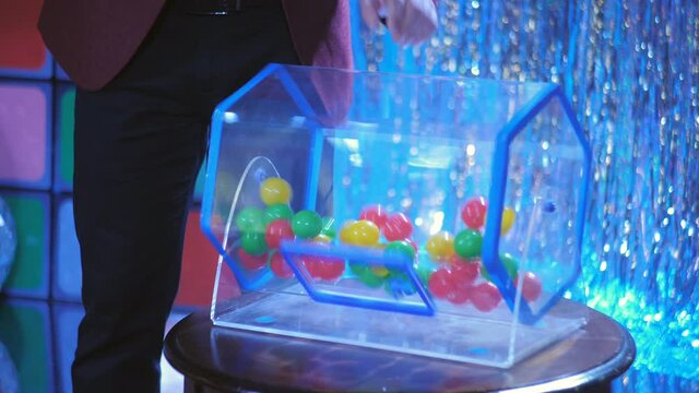 Plastic balls are mixed in a bingo drum. the drawing of prizes using a Lotto.