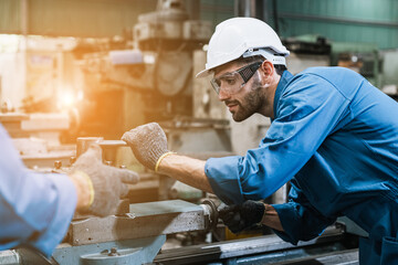 Engineering worker man wearing uniform safety and hardhat working machine lathe metal in factory...