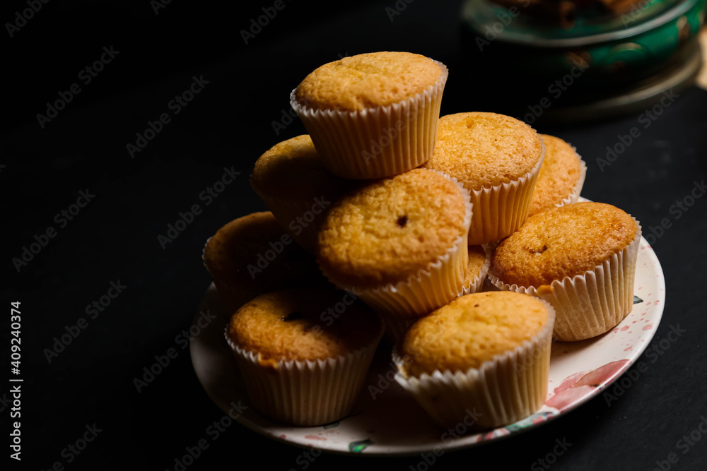 Wall mural cupcakes on a black background. baking