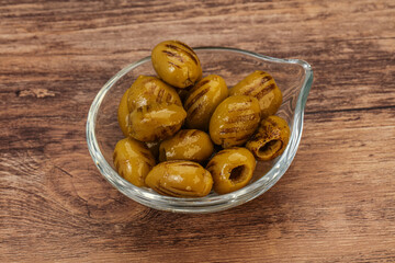 Green grilled olives in the bowl
