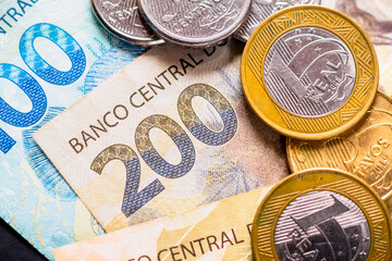 In this photo illustration the detail of the two hundred reais note and a few real coins, twenty-five cents. The Real is the current money in Brazil.
