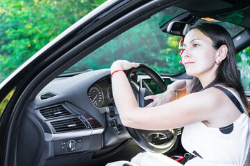 beautiful woman driving and smiling. portrait of happy girl in the car. traveling. enjoying the life