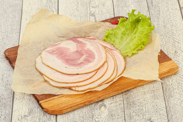 Sliced Pancetta sausage over board