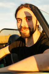 White european man with dark hair portrait in the car