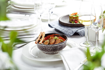Caesar salad with bread sticks, quail eggs, cherry tomatoes and grilled chicken in plate on white background