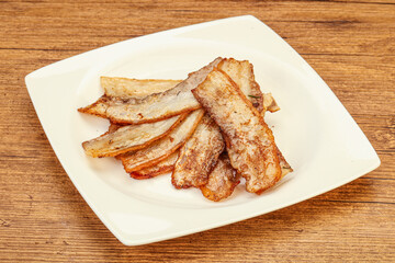 Roasted juicy bacon in the plate