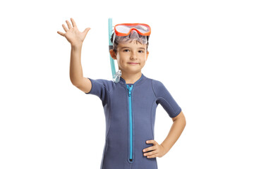 Kid wearing a wetsuit, diving mask and flippers and waving at the camera