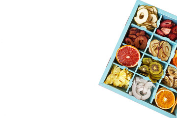 Box with dried fruits chips isolated on white, top view.