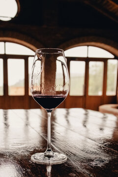 A glass of red wine on rustic wooden table