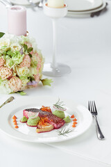 Tender dorado fillet with vegetables and basil. Banquet festive dishes. Gourmet restaurant menu. White background.