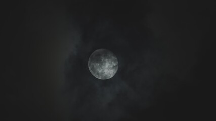 Full moon against cloudy night sky