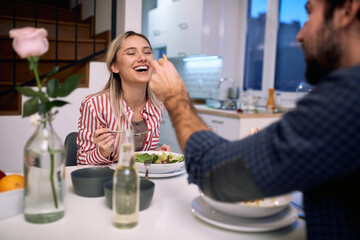 A young couple having fun while eating. Home, kitchen, meal, relationship
