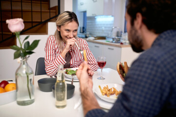 A young couple likes eating together. Home, kitchen, meal, relationship