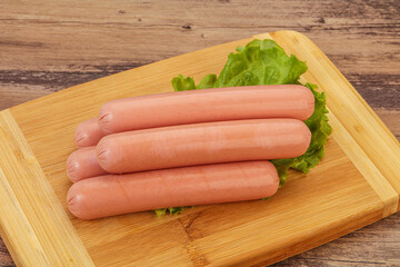 Tasty meat sausages over board