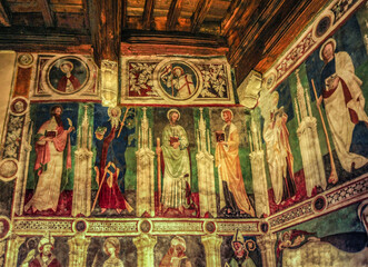 Fototapeta na wymiar Frescoes adorn the pentagonal courtyard of Fenis Castle and its chapel, built in the 14th century and painted by the Italian master Giacomo Gianeiro. 