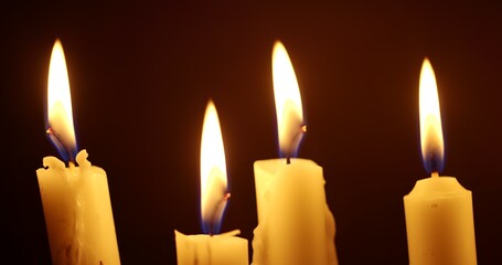 Candles glowing against dark background