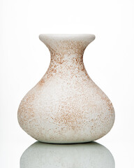 Beige ceramic vase with a white background