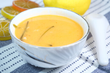 Thai hot spicy soup in bowl on table 