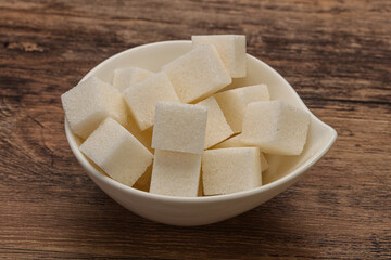 Refined white sugar cubs in the bowl