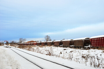 Obraz premium Railroad tracks in winter time. Railway infrastructure. Steel railway for trains in snow