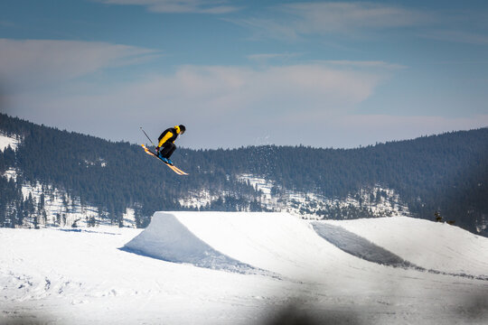Skier skiing in the snowpark and jumping in air 