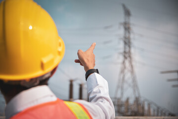 Electrician pointing at the electric tower