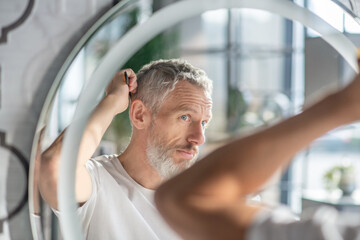 Man combing his hair in the morning