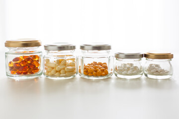 Health concept. Glass bottles of vitamin in morning light.